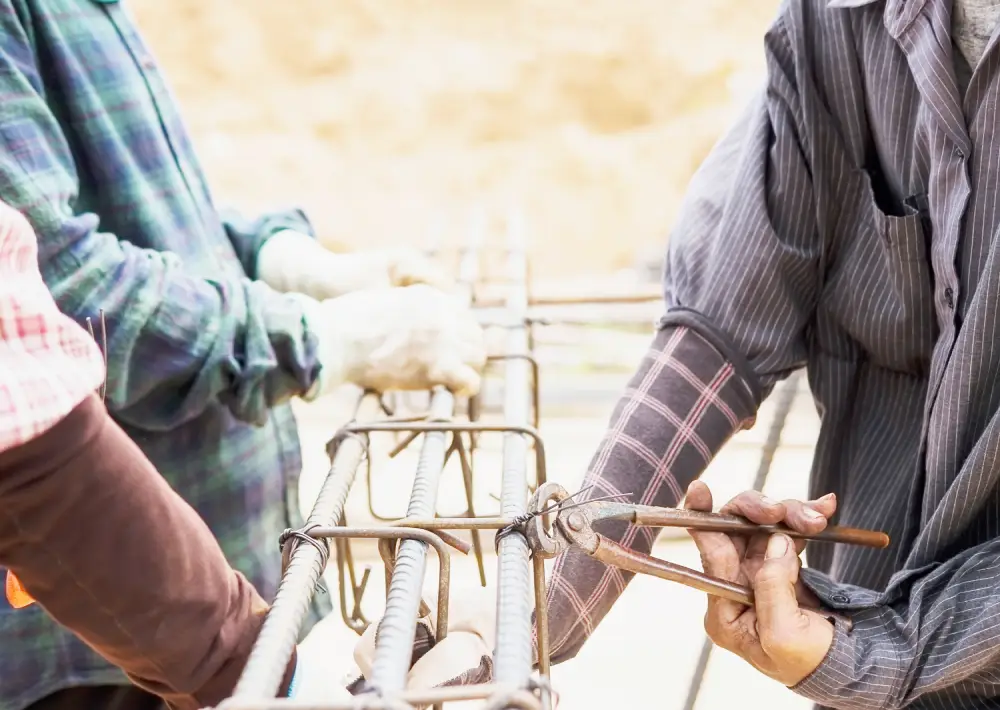 construction workers are installing steel rods reinforced concrete column