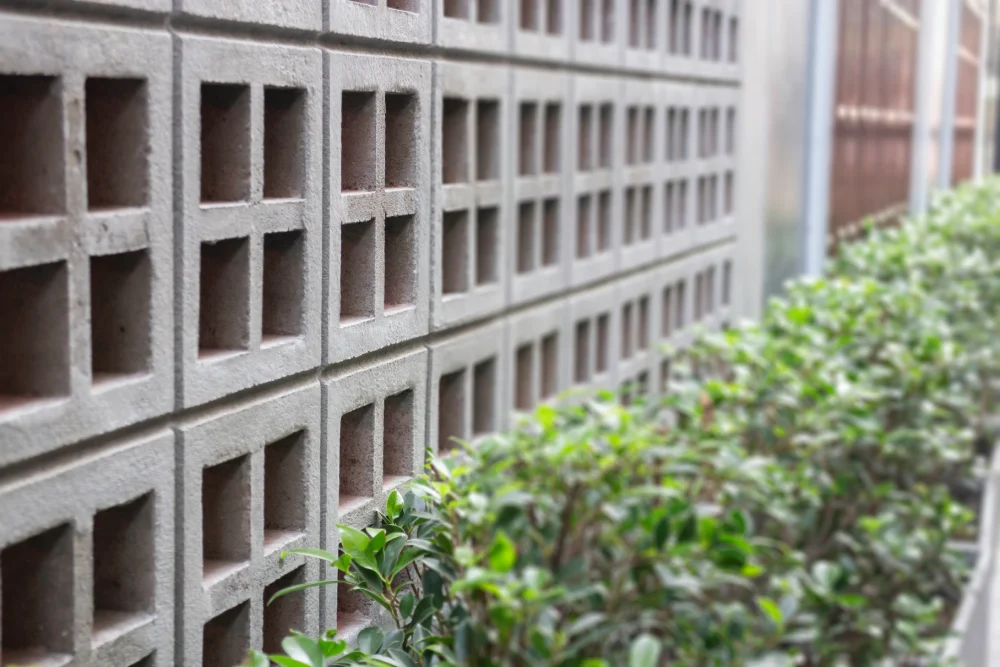 Breeze block facade in modern architecture using concrete hollow blocks to create a clean geometric screen for natural light and ventilation.
